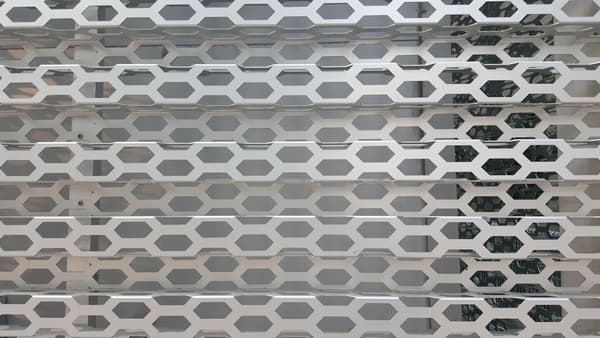 Hexagonal perforated building exterior material